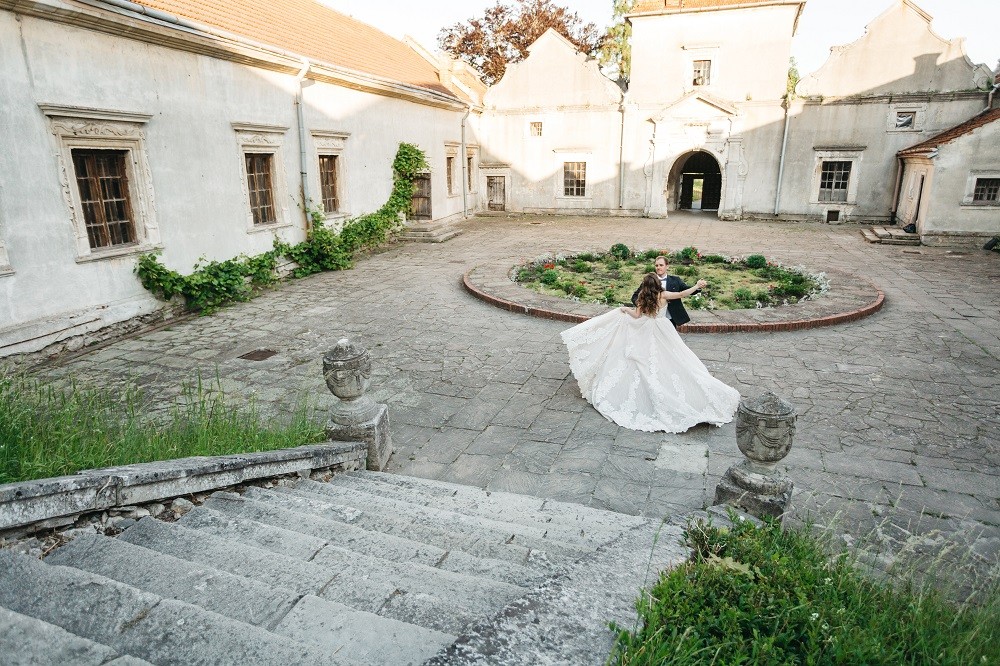 happy brides dance near castle